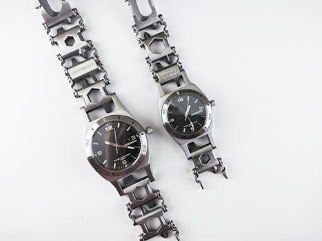 Two stylish stainless steel wristwatches displayed on a white surface highlighting their modern design.